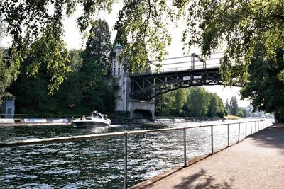 Bridge over river against trees