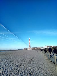 Scenic view of beach against clear blue sky