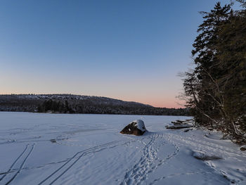 Scenic view of snow covered field against clear sky