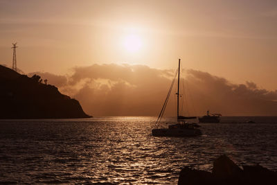 Sailboat on sea against sky during sunset