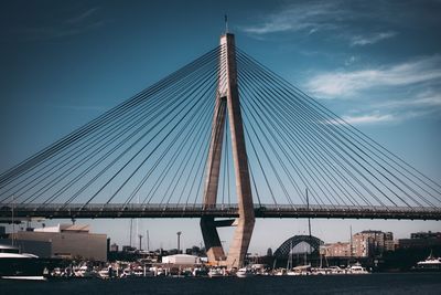 Low angle view of bridge and buildings against sky