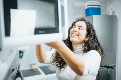 Portrait of young woman standing in laboratory