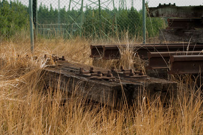 Abandoned metal fence on field