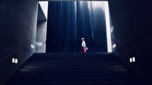 Low angle view of woman standing on staircase