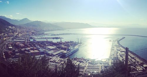 Close-up of sea by mountains against sky