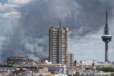 Buildings in city against cloudy sky