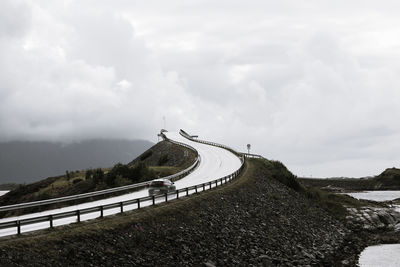 Road by mountain against sky