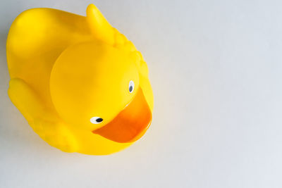 Close-up of yellow toy over white background