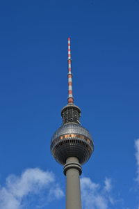 Low angle view of communications tower against sky