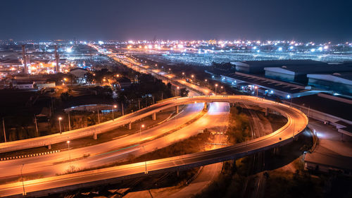 U turn bridge traffic transportation at night over lighting and factory zone with commercial dock 