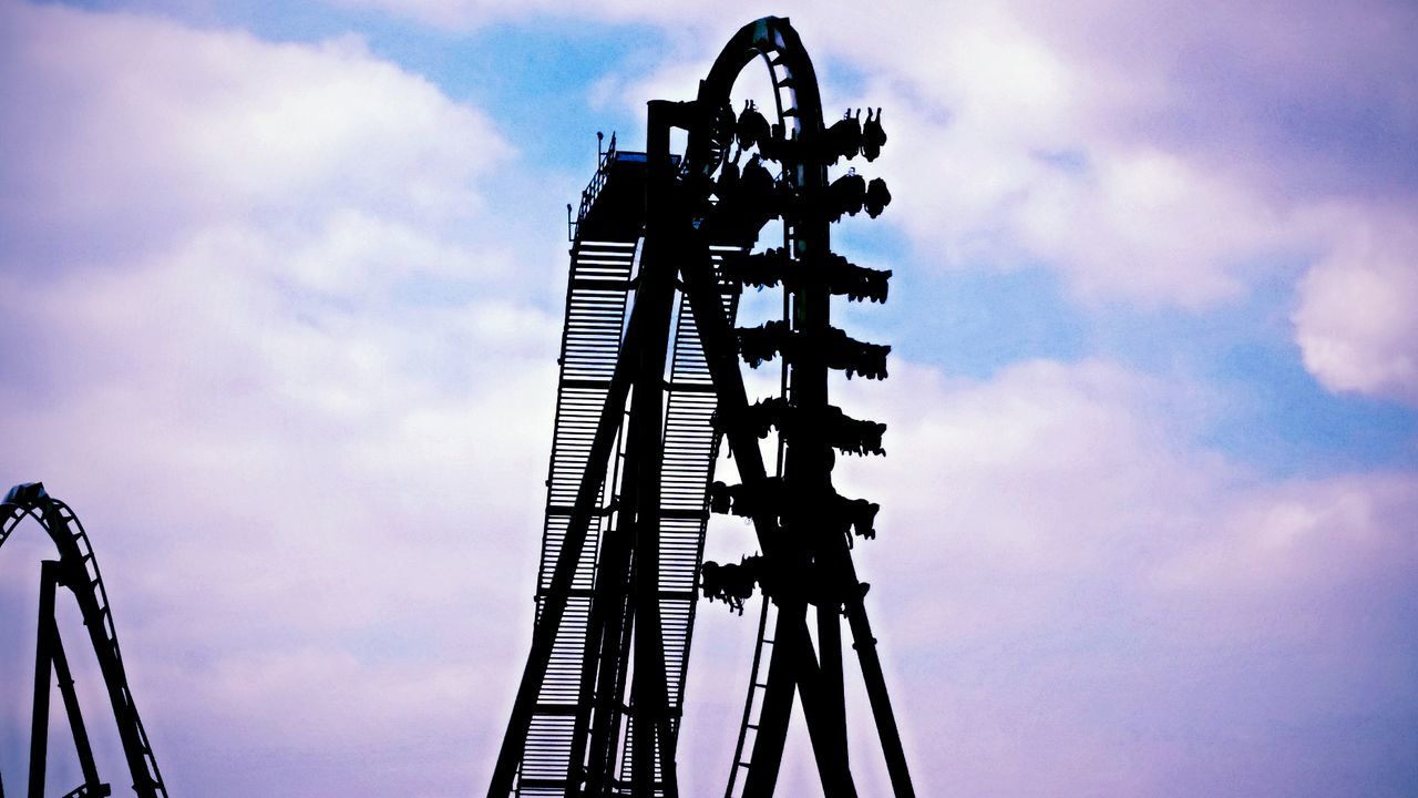 sky, low angle view, cloud - sky, cloudy, metal, built structure, arts culture and entertainment, cloud, metallic, architecture, ferris wheel, amusement park ride, amusement park, outdoors, no people, tall - high, day, overcast, travel destinations, silhouette