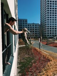 Man by buildings in city