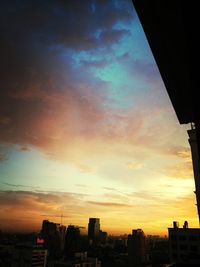 Low angle view of buildings against sky at sunset