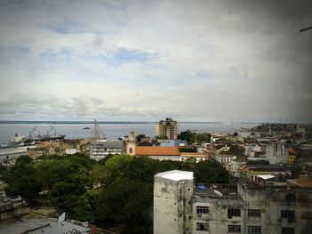 Buildings against cloudy sky