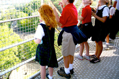 Woman standing by railing