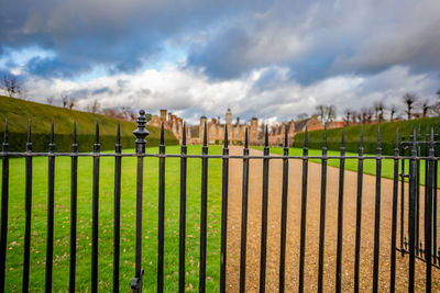 Fence on field against sky