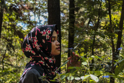 Close-up of woman with eyes closed in forest