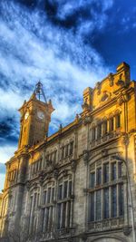 Low angle view of building against cloudy sky