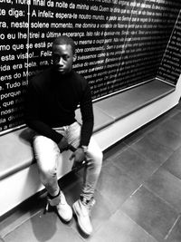 Portrait of young man sitting on floor