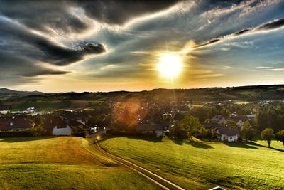 Scenic view of field against sky at sunset