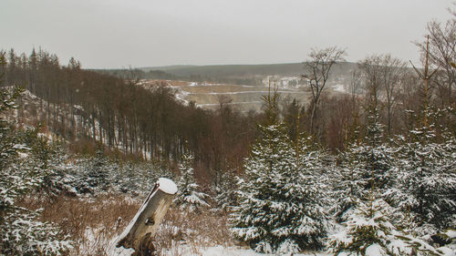 Scenic view of snow covered land against sky