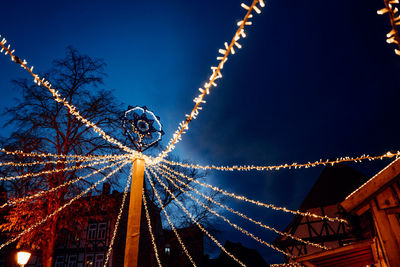 Low angle view of illuminated christmas lights against clear sky at night