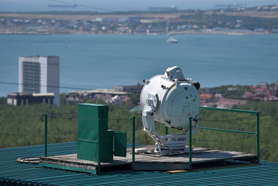 Aerial view of factory by sea against sky