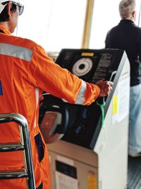 Midsection of man standing on bus