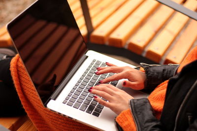 Female hands typing on computer keyboard