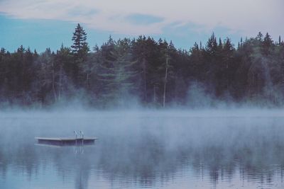 Diving platform over lake during foggy weather