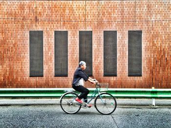 Man riding bicycle on city street