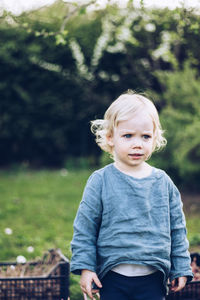 Cute baby girl standing in park