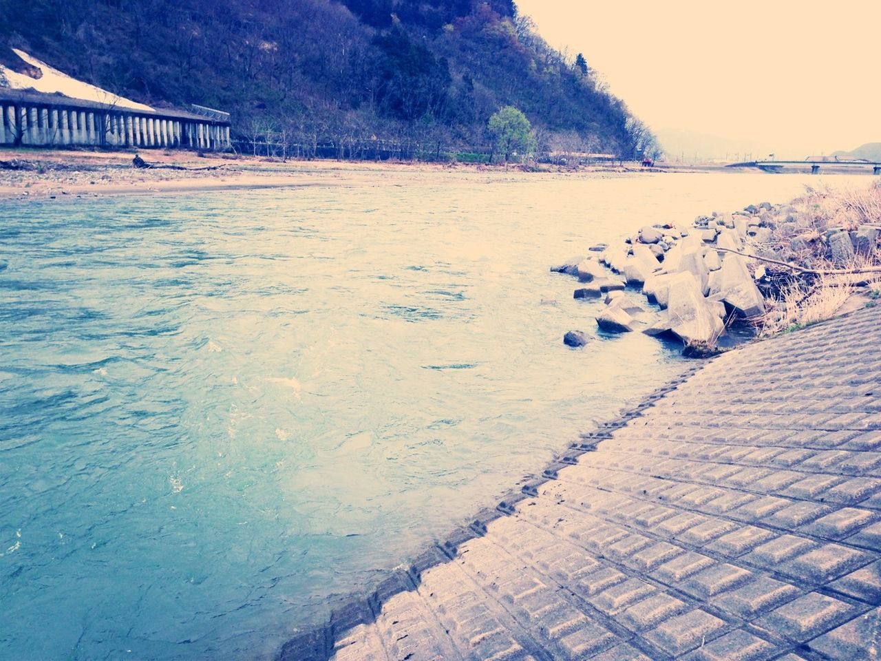 water, mountain, tranquility, tranquil scene, scenics, sunlight, nature, railing, beauty in nature, built structure, shadow, high angle view, beach, sand, day, outdoors, river, the way forward, sea, no people