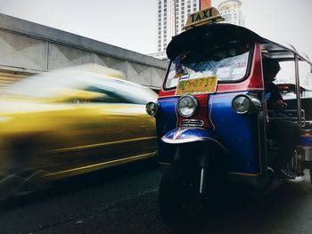 Close-up of man driving car against sky