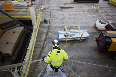 Engineer walking down stairs at construction site