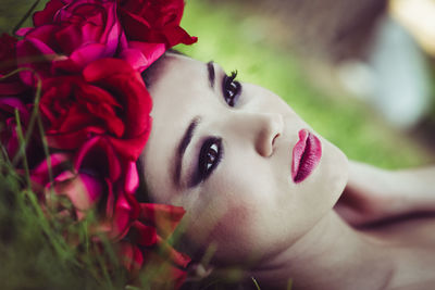 Close-up of woman wearing pink lipstick with flowers