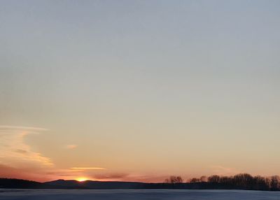 Scenic view of sea against clear sky during sunset