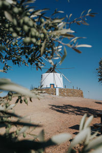 Traditional windmill against clear blue sky