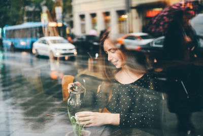 Midsection of woman drinking glass