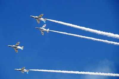 Low angle view of aircraft in mid-air during airshow