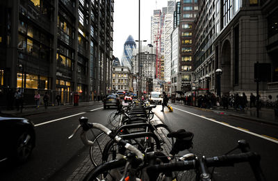 Vehicles on road by buildings in city