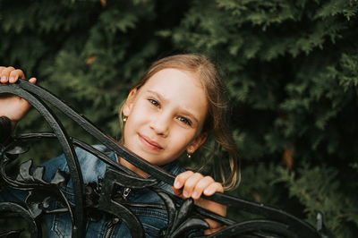 Thoughtful serious candid kid girl face peeking out of abstract shapes. children mind psychology