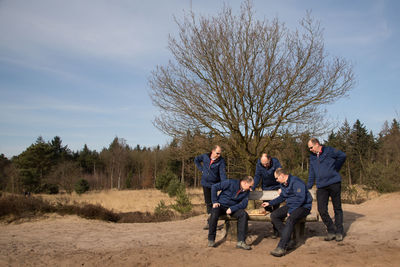 Multiple image of man playing chess in forest