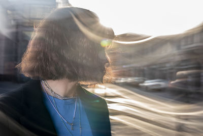 Rear view of woman standing on road