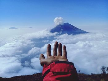 Person on mountain against sky