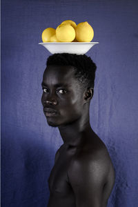 Portrait of shirtless man against white background