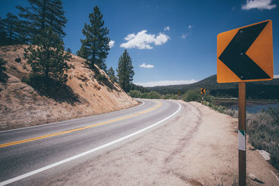 Road sign against sky