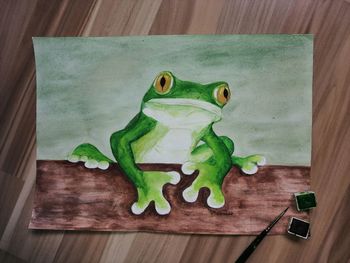Close-up of frog on table