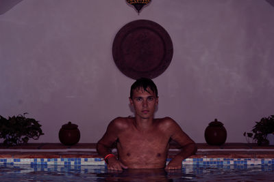 Portrait of man in swimming pool at night