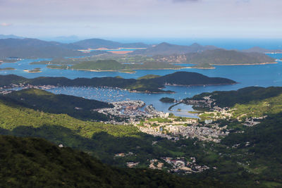 Scenic view of sea and mountains against sky
